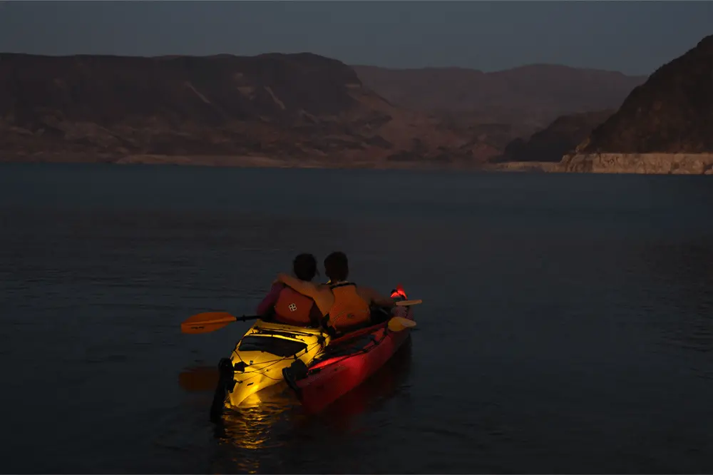 Kayakers enjoying calm water near sunset