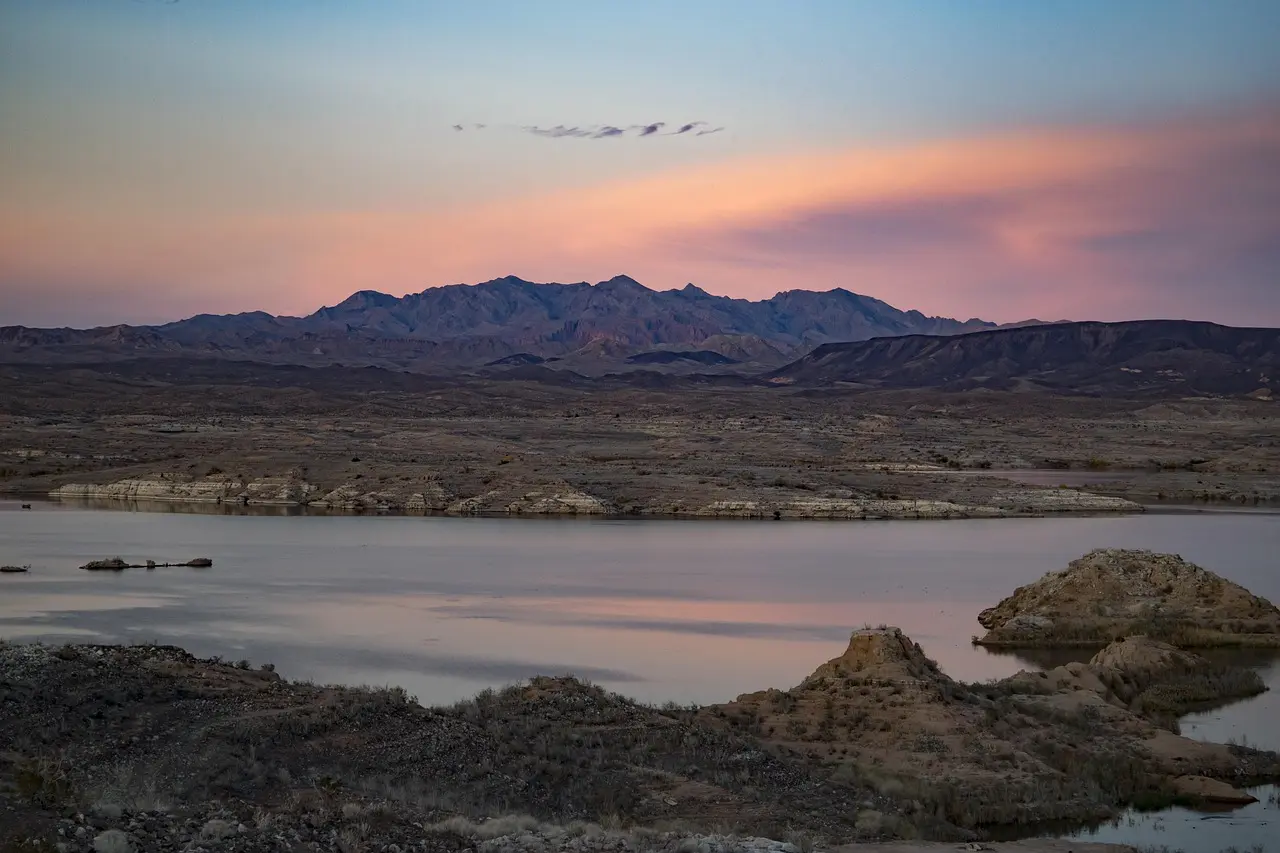 Lake Mead and desert mountains beneath a colorful sunset