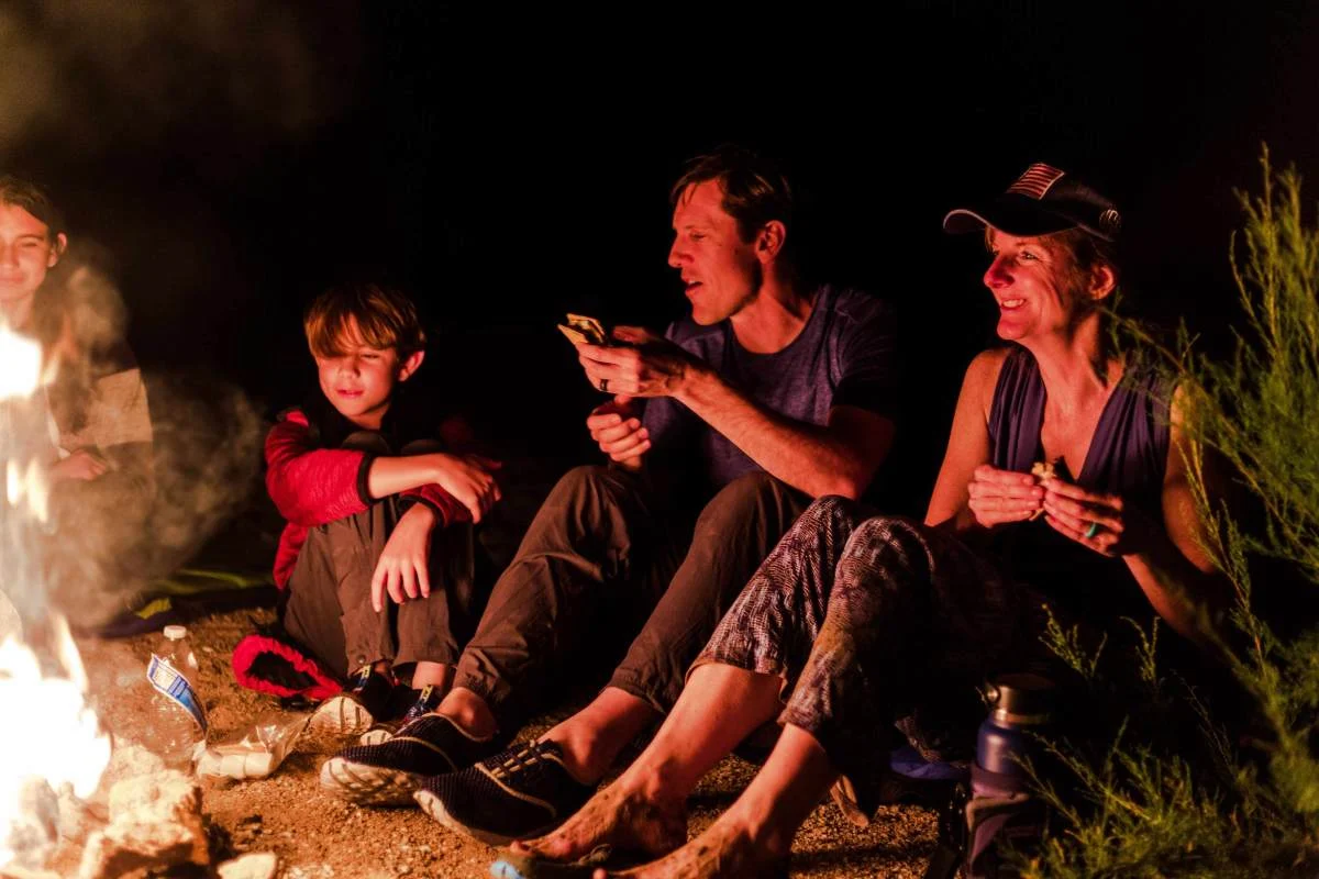 Family relaxing around a campfire