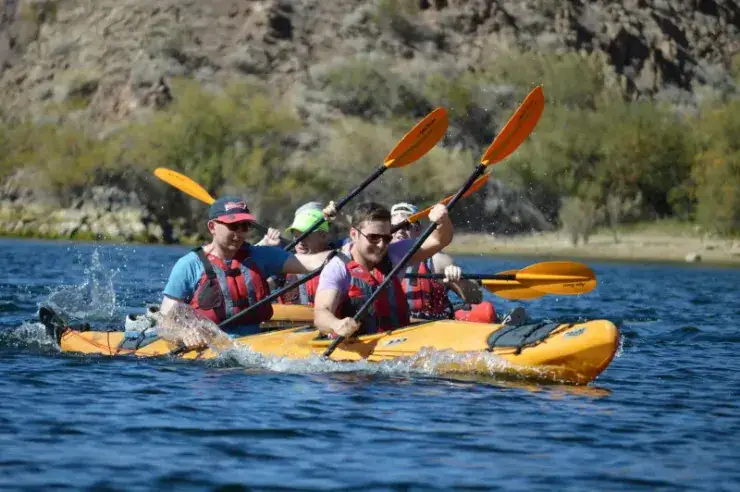 Group paddling a multi-person kayak on the Colorado River