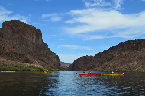 Kayakers paddling through the towering walls of Black Canyon