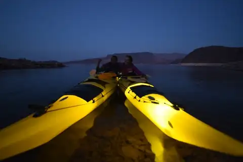 Yellow kayaks resting on the shore as dusk settles over Black Canyon