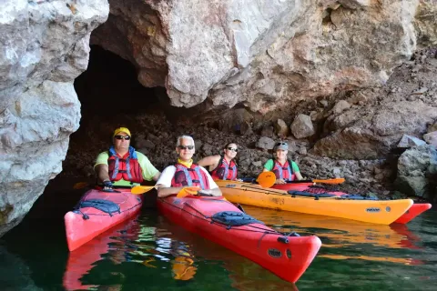 A group of guests kayaking inside an Emerald Cave