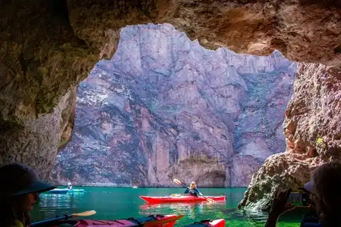 Guide leading a kayak into Emerald Cave