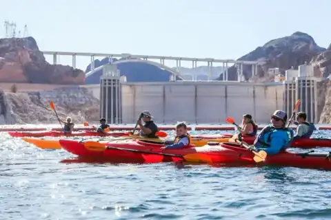 Kayaker paddling toward Hoover Dam from Lake Mead