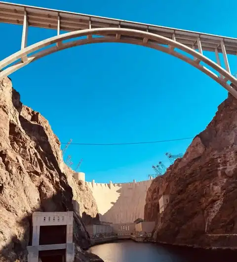 Looking up at the bypass bridge arching over Hoover Dam