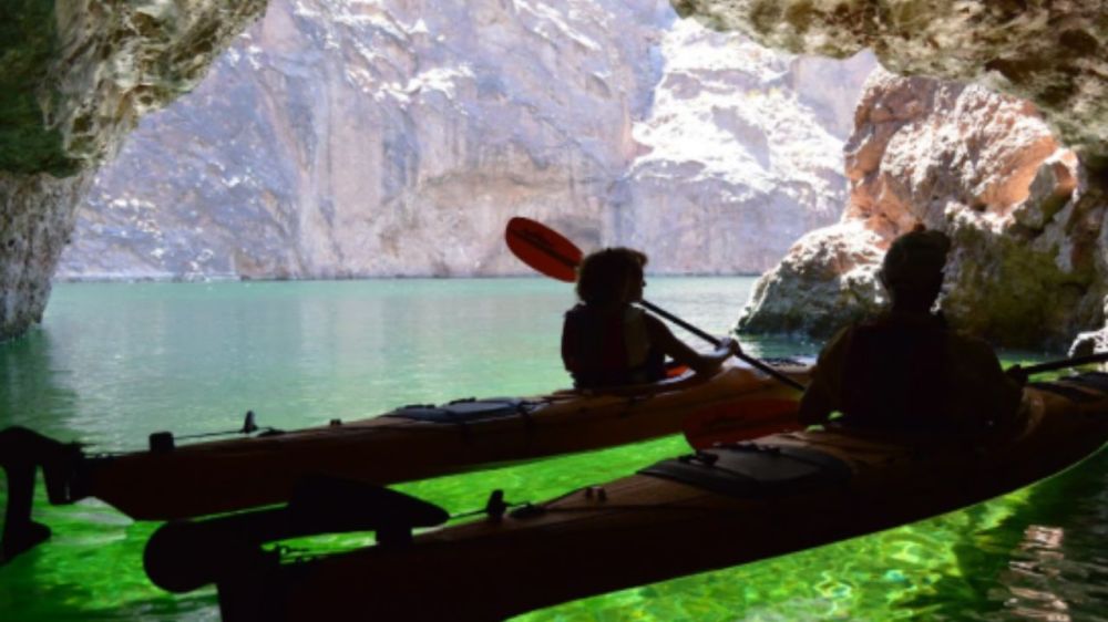 The green glow inside Emerald Cave shows as kayakers explore the cave in Black Canyon, near Willow Beach, Arizona. 