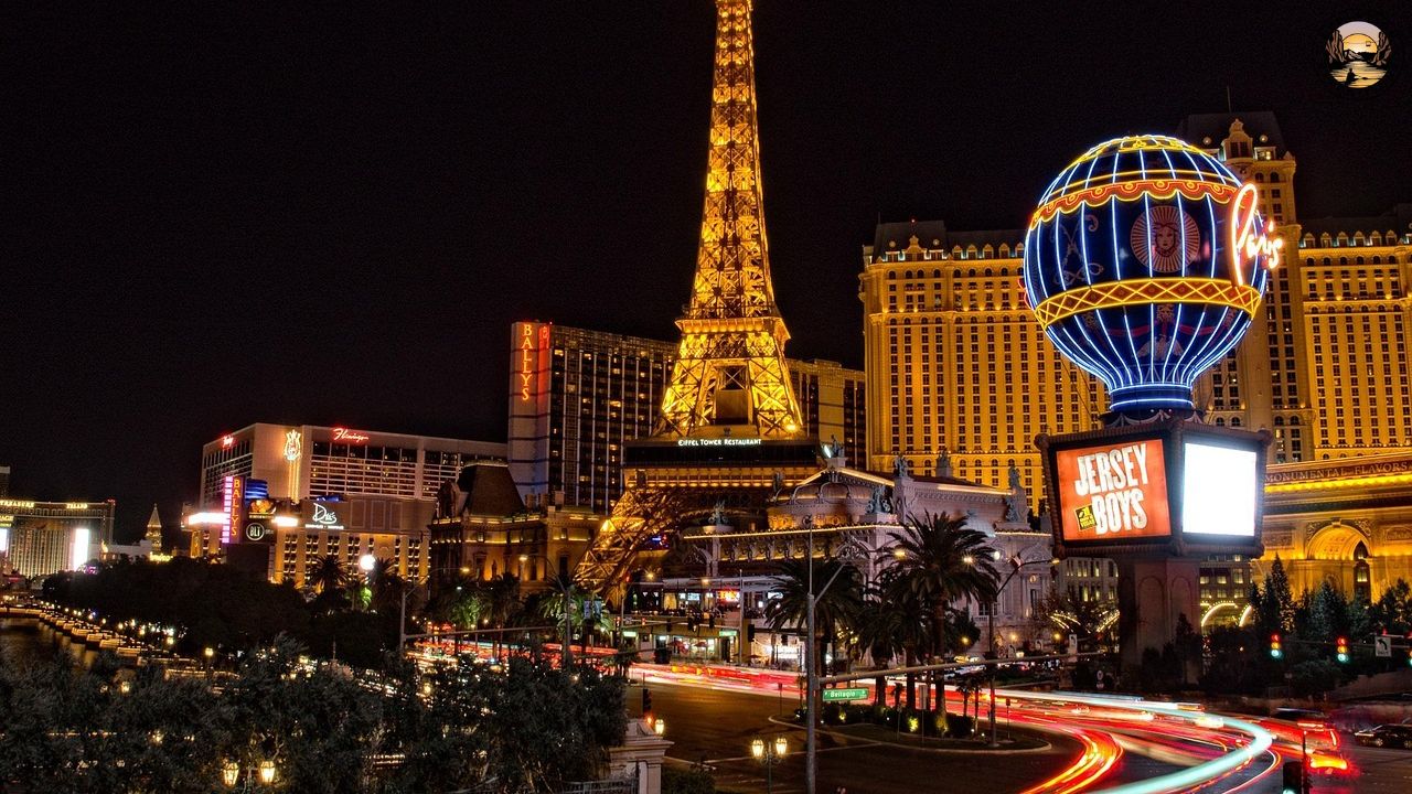 Las Vegas at night with Eiffel Tower replica and neon lights.