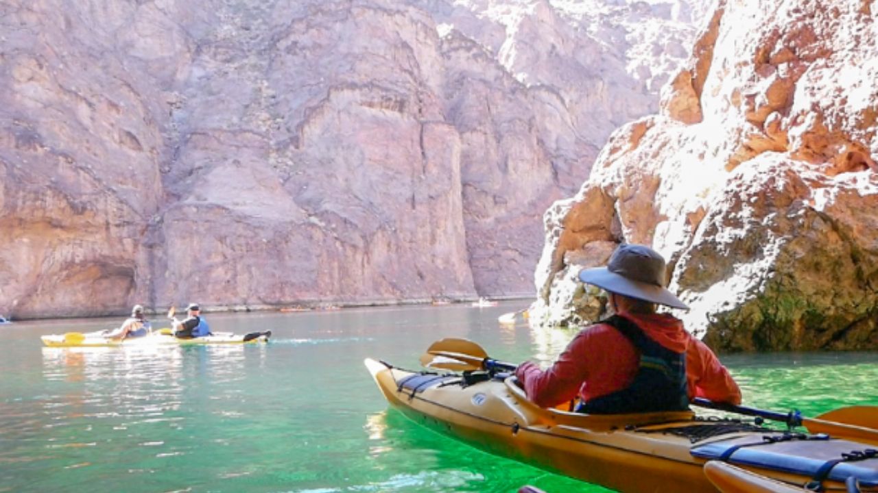A kayaker paddling in Emerald Cave as part of a guided tour by Evolution Expeditions.