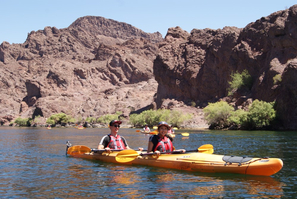 Kayakers paddling on the Black Canyon as part of Evolution Expeditions tour.
