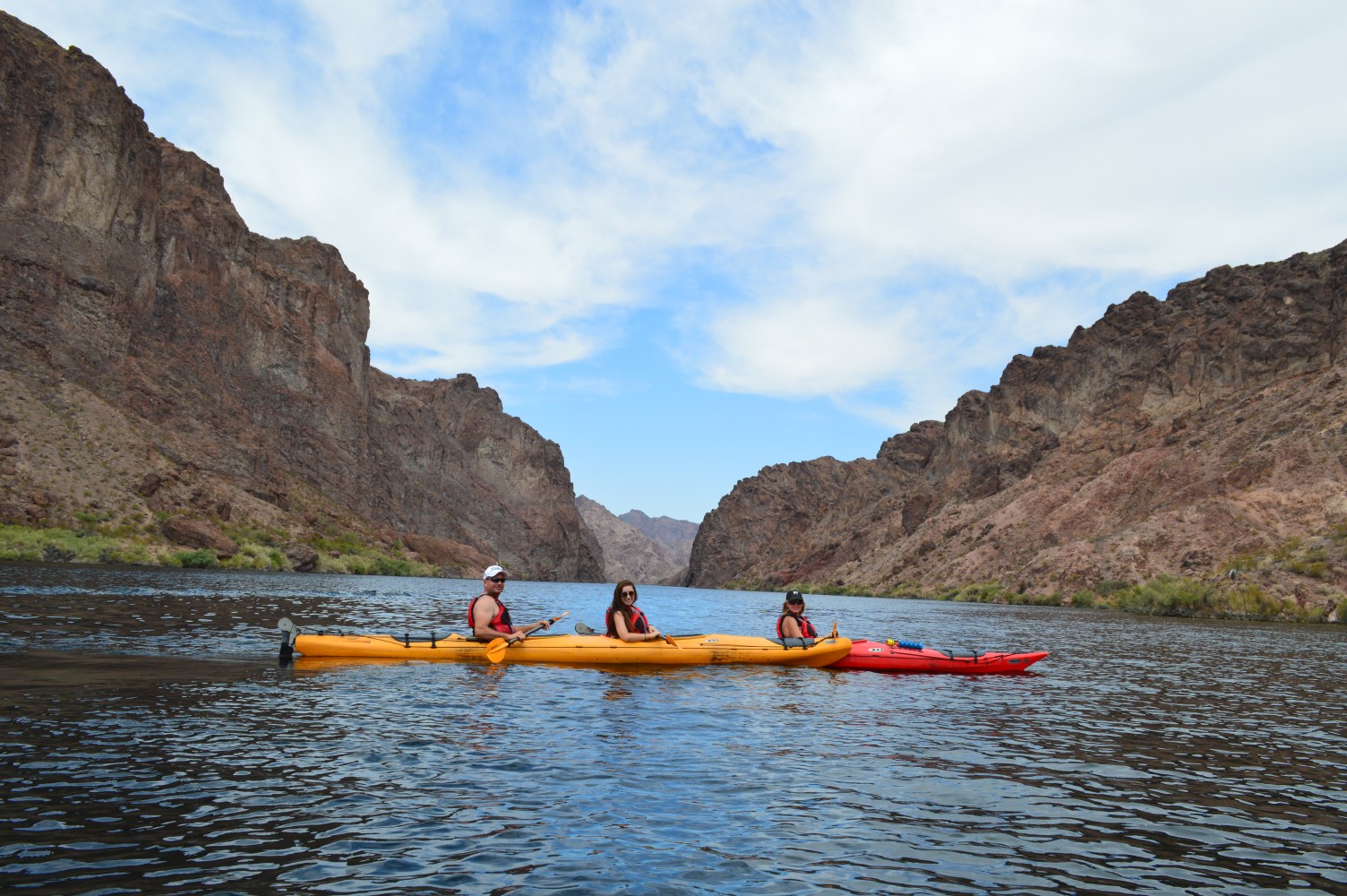 Kayakers paddling through the Emerald green waters as part of the Evolution Expeditions Emerald Cave tour.