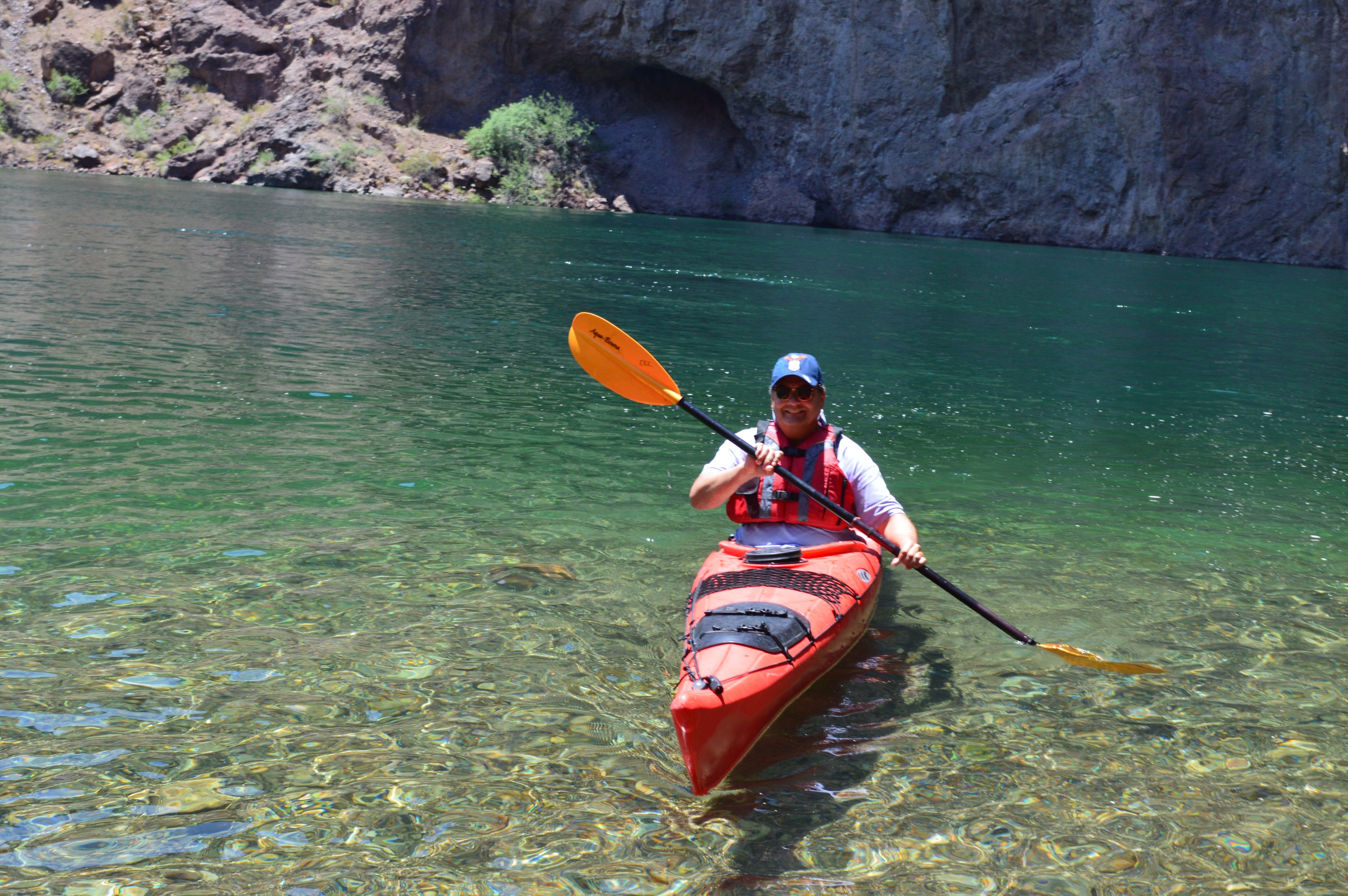 A kayaker paddling on emerald green waters during an Evolution Expeditions guided tour.
